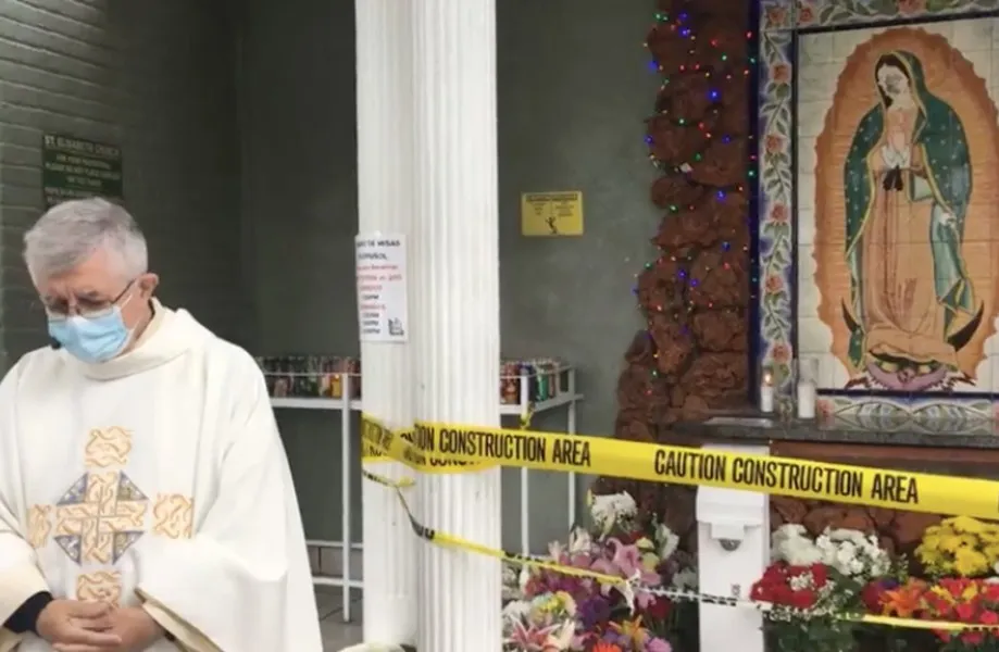 Fr. Vito Di Marzio, pastor of St. Elisabeth of Hungary parish, prays in front of the defaced mural?w=200&h=150